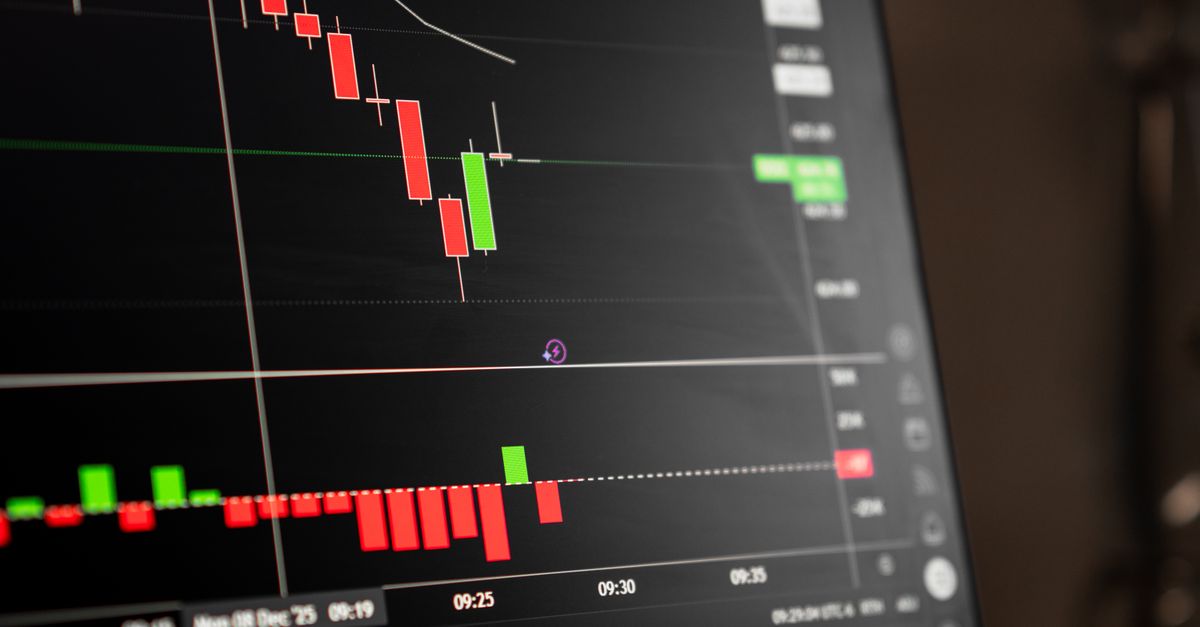 A minimalist book cover of 'The Psychology of Money' next to a digital screen showing a volatile stock candle chart.