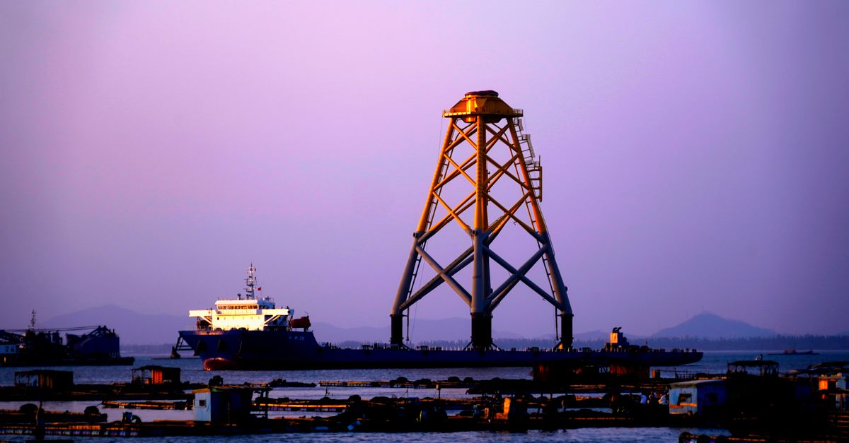 A high-resolution photo of a Chevron offshore platform in Guyana at sunset.